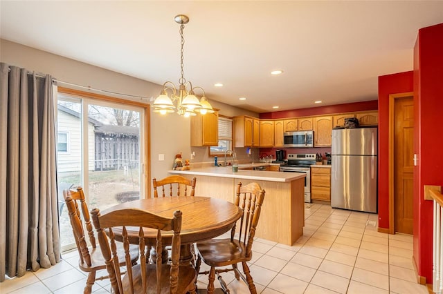 tiled dining area featuring an inviting chandelier and sink