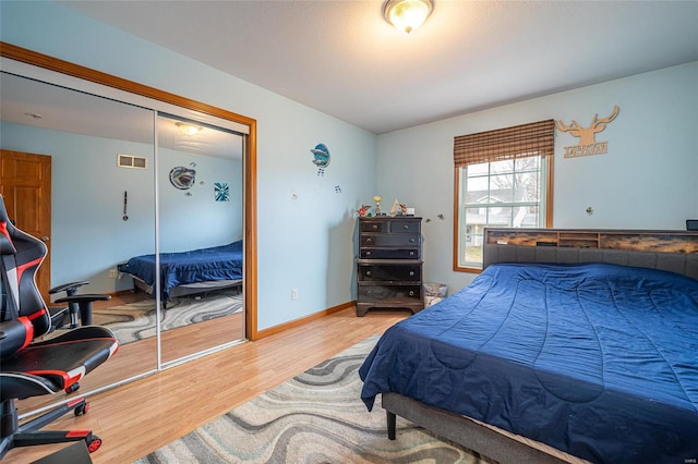 bedroom featuring wood-type flooring and a closet