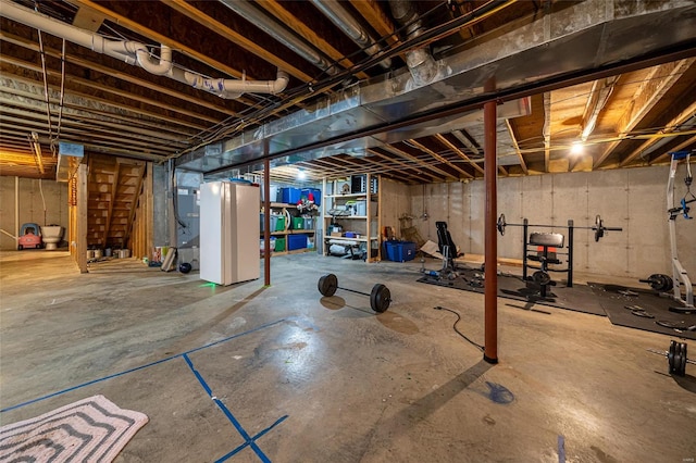 basement featuring white fridge