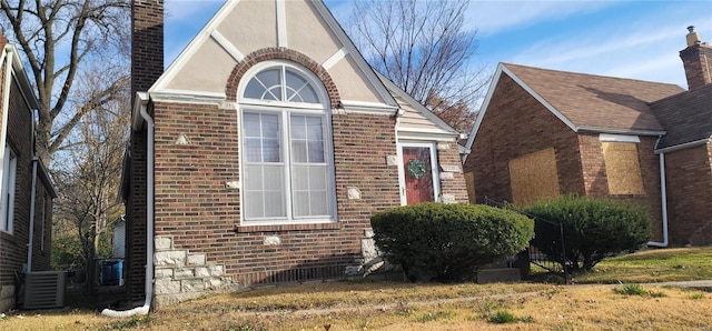 view of home's exterior featuring cooling unit and a yard