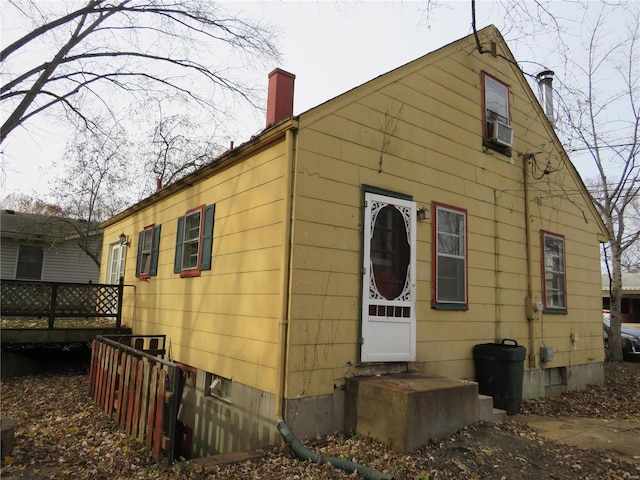 back of property featuring a wooden deck