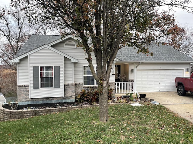 view of front of property featuring a garage and a front lawn