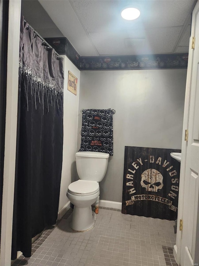 bathroom with tile patterned flooring and toilet