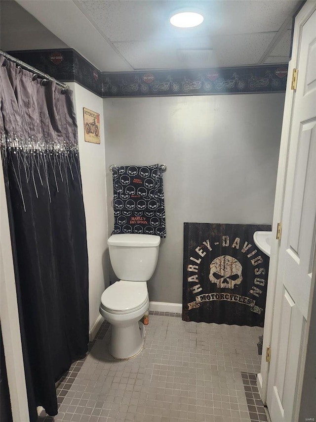 bathroom with tile patterned flooring and toilet