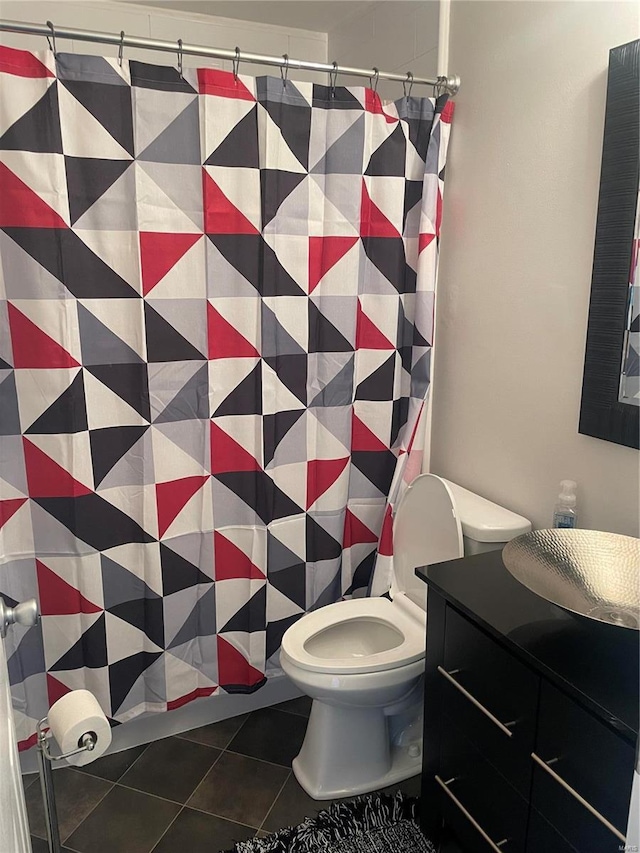 bathroom featuring tile patterned flooring, vanity, and toilet