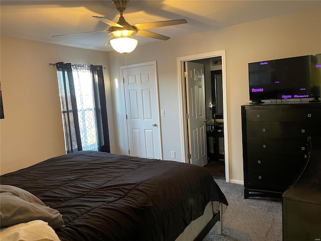 carpeted bedroom with ensuite bathroom and ceiling fan