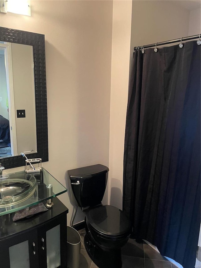 bathroom featuring tile patterned floors, vanity, and toilet