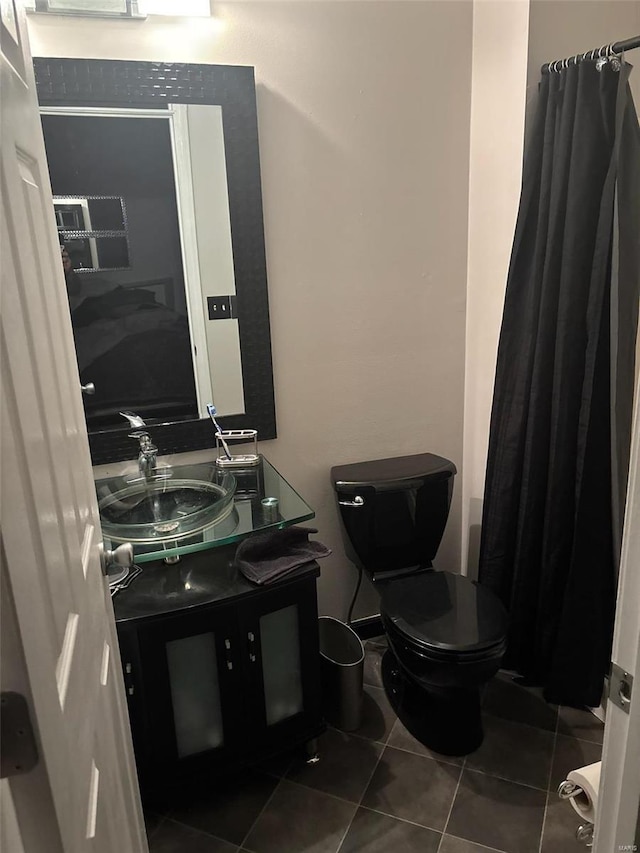 bathroom featuring tile patterned flooring, vanity, and toilet