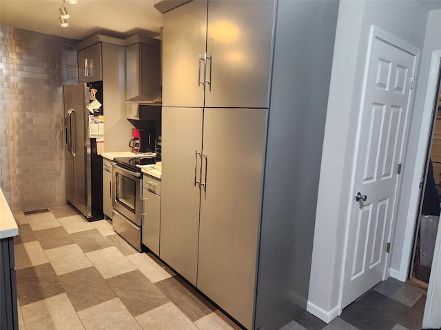 kitchen with appliances with stainless steel finishes, gray cabinets, and ventilation hood