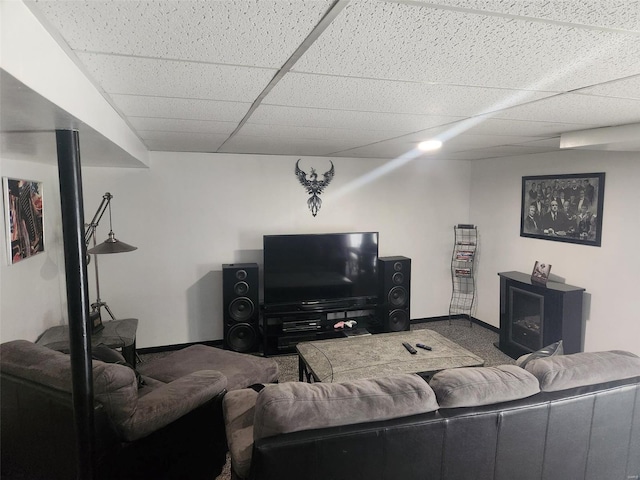 living room featuring carpet and a drop ceiling