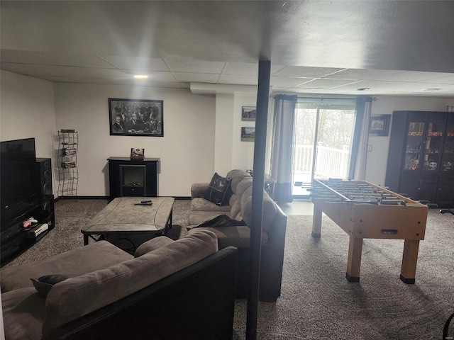 recreation room featuring a paneled ceiling and carpet floors