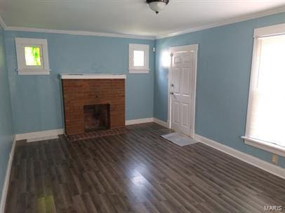 unfurnished living room with crown molding, dark hardwood / wood-style flooring, and a fireplace