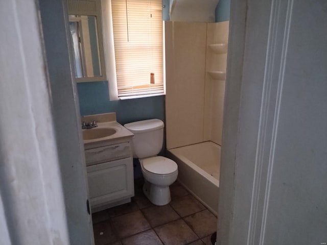 bathroom featuring toilet, a shower, and vanity