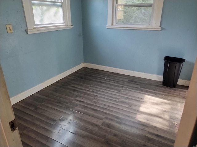 empty room featuring dark wood-type flooring