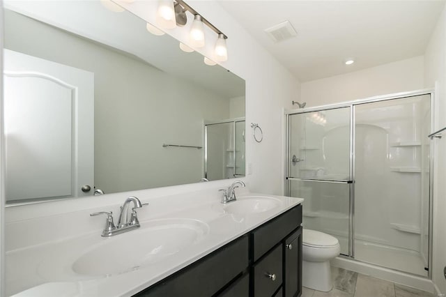 bathroom featuring vanity, toilet, and a shower with door