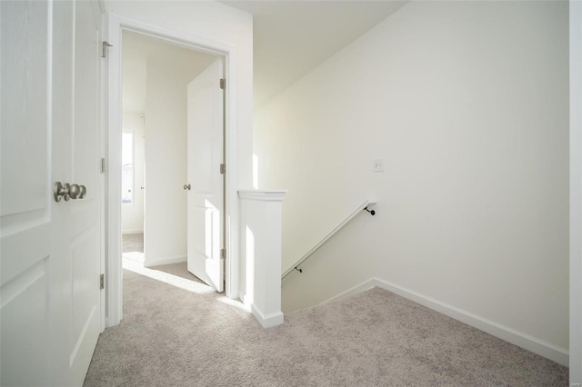 hall featuring light colored carpet