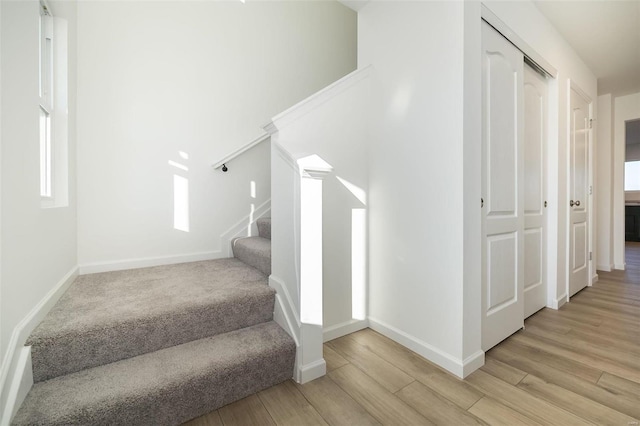 stairs featuring wood-type flooring