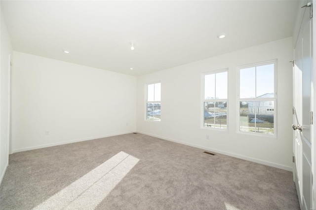 empty room featuring light colored carpet