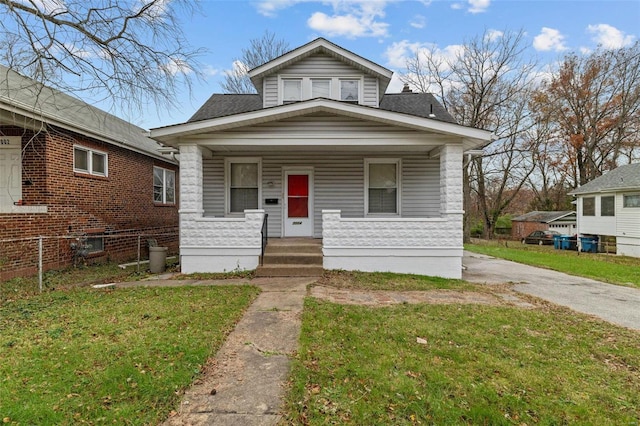 bungalow-style home with a front yard