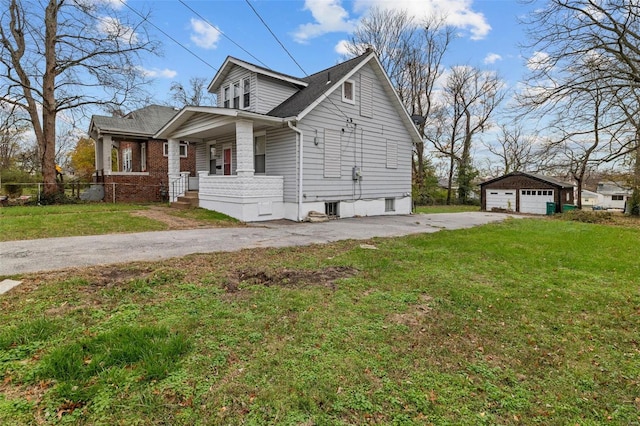 view of front of house featuring a front lawn, an outdoor structure, and a garage