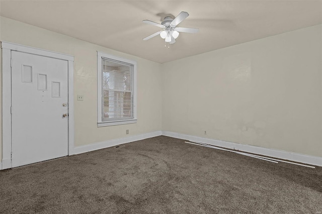 carpeted spare room featuring ceiling fan