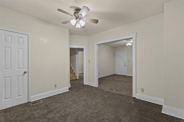 unfurnished bedroom featuring dark colored carpet and ceiling fan