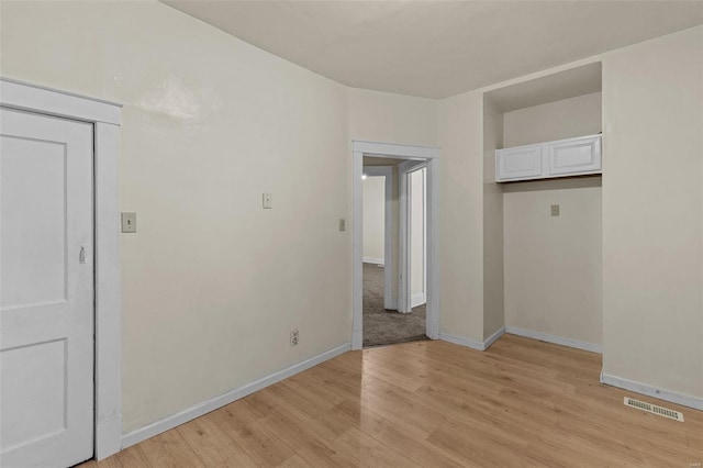 unfurnished bedroom with light wood-type flooring