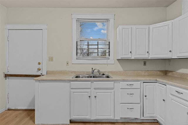 kitchen featuring sink, white cabinets, and light hardwood / wood-style floors