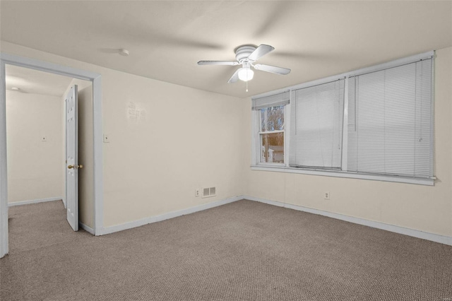 carpeted spare room with ceiling fan