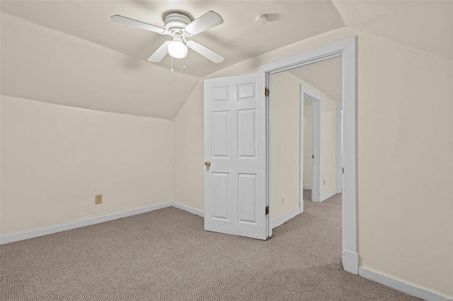 bonus room with ceiling fan, light colored carpet, and vaulted ceiling