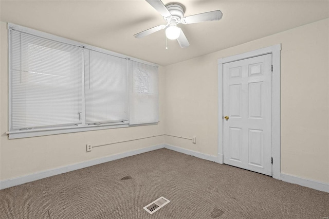 empty room with ceiling fan and light colored carpet