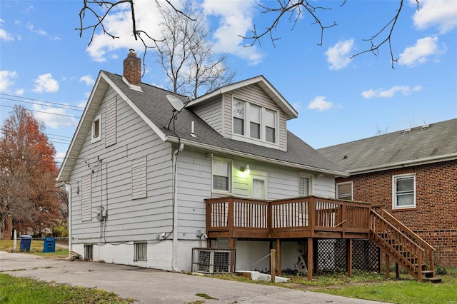 back of house featuring a wooden deck