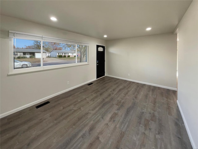 unfurnished room featuring dark hardwood / wood-style flooring