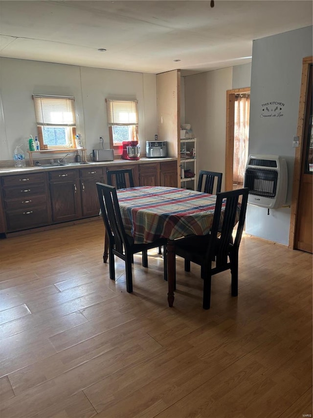 dining room featuring light hardwood / wood-style floors and heating unit