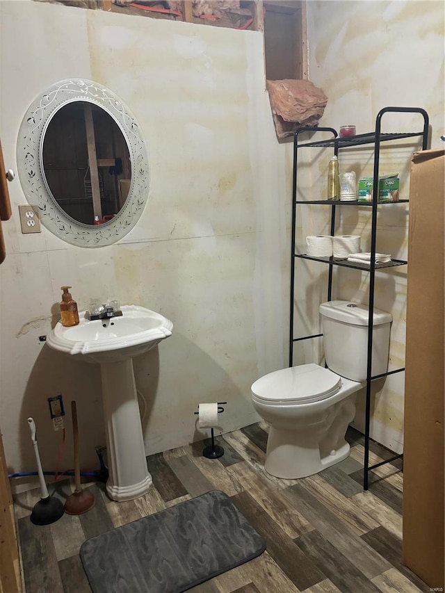 bathroom featuring hardwood / wood-style flooring and toilet