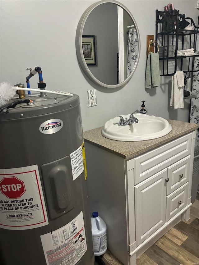 bathroom with vanity, wood-type flooring, and electric water heater