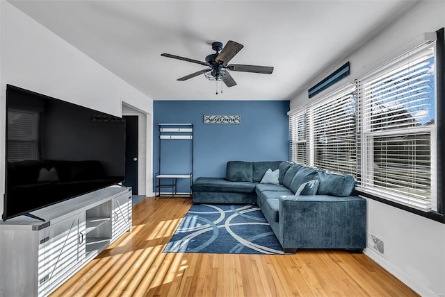 living room featuring ceiling fan and hardwood / wood-style flooring