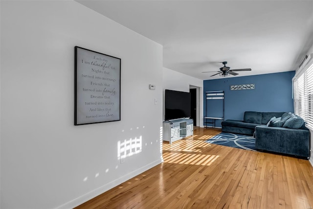 living room with hardwood / wood-style floors and ceiling fan