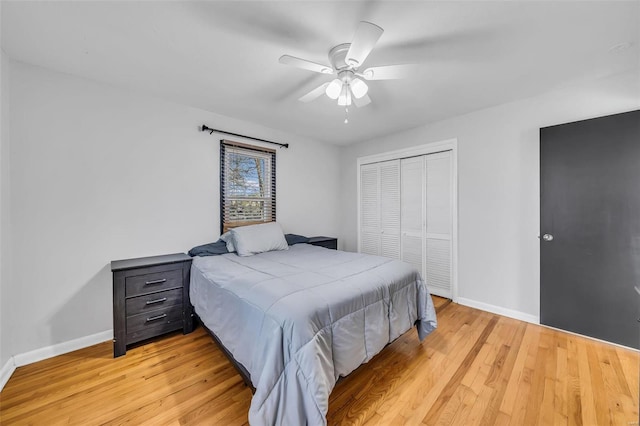 bedroom with ceiling fan, a closet, and light hardwood / wood-style floors