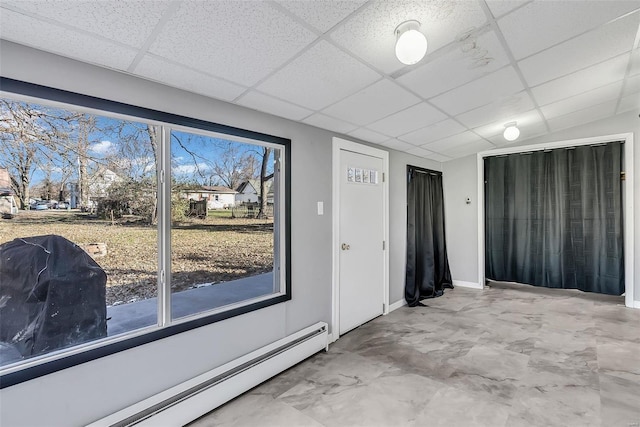 foyer entrance featuring a paneled ceiling and a baseboard radiator