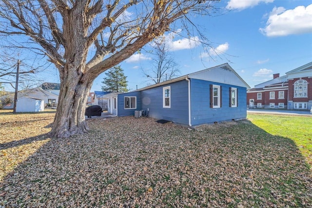 view of home's exterior with a lawn and cooling unit