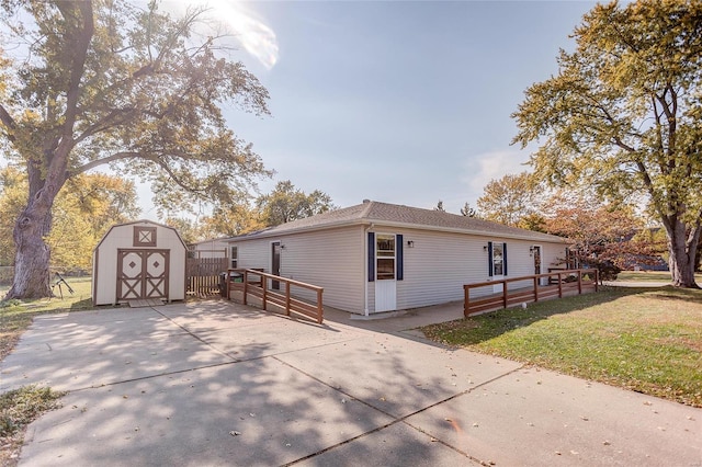 view of home's exterior featuring a lawn and a storage shed