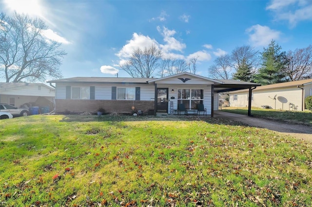 ranch-style house featuring an attached carport, concrete driveway, and a front lawn