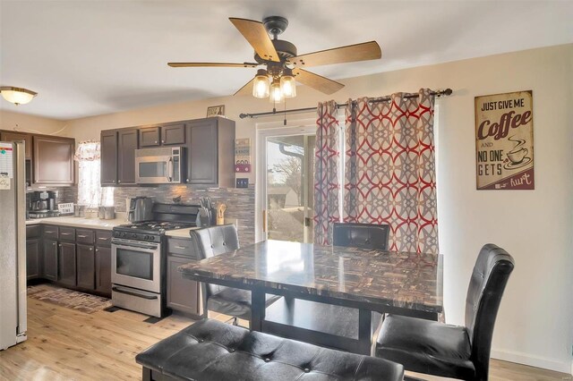 kitchen featuring light countertops, light wood-style floors, tasteful backsplash, and stainless steel appliances