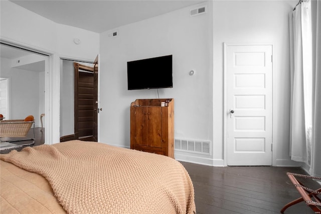 bedroom featuring dark hardwood / wood-style flooring and a closet