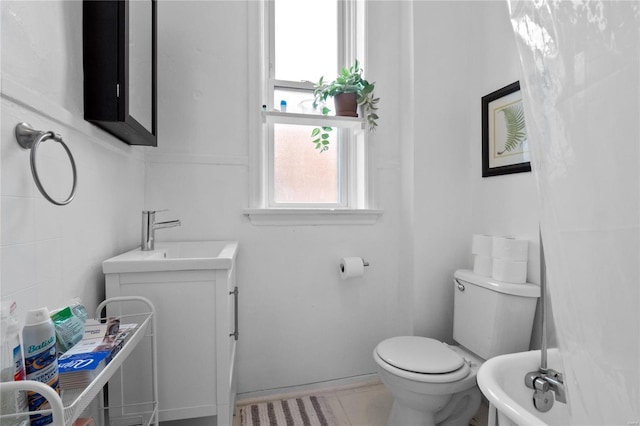 bathroom featuring tile patterned floors, vanity, and toilet