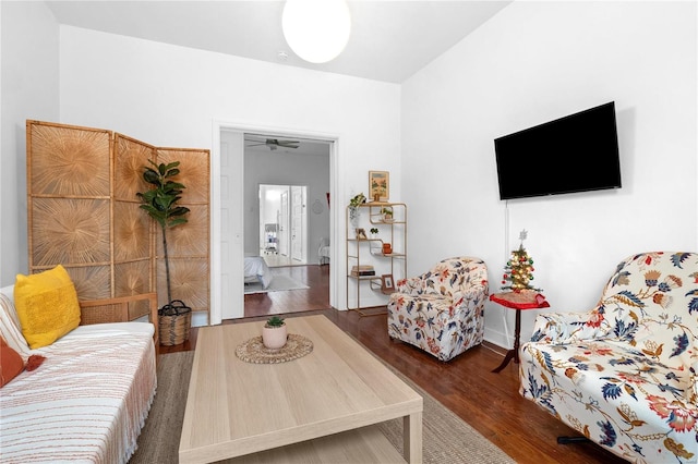 living room featuring dark hardwood / wood-style floors and ceiling fan