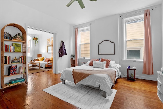 bedroom with ceiling fan and light wood-type flooring