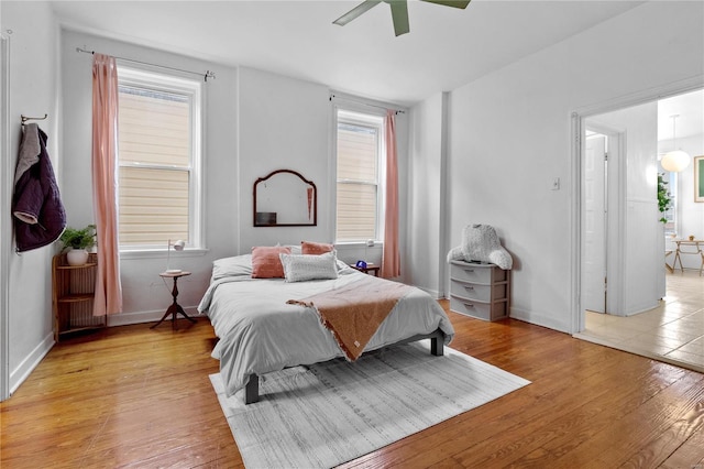 bedroom with ceiling fan and light wood-type flooring