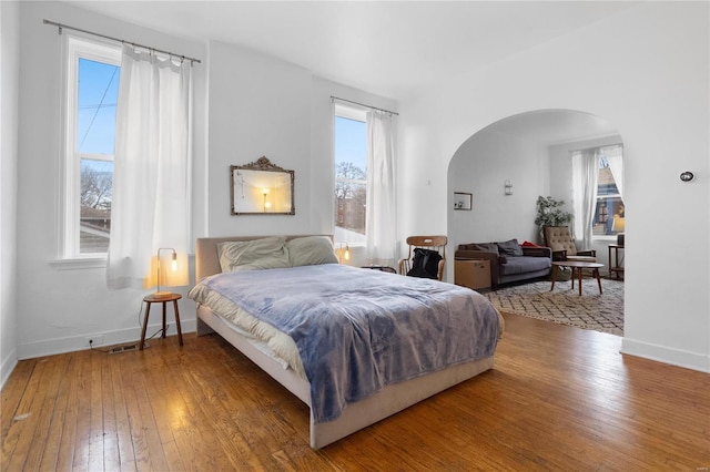 bedroom featuring hardwood / wood-style floors and multiple windows